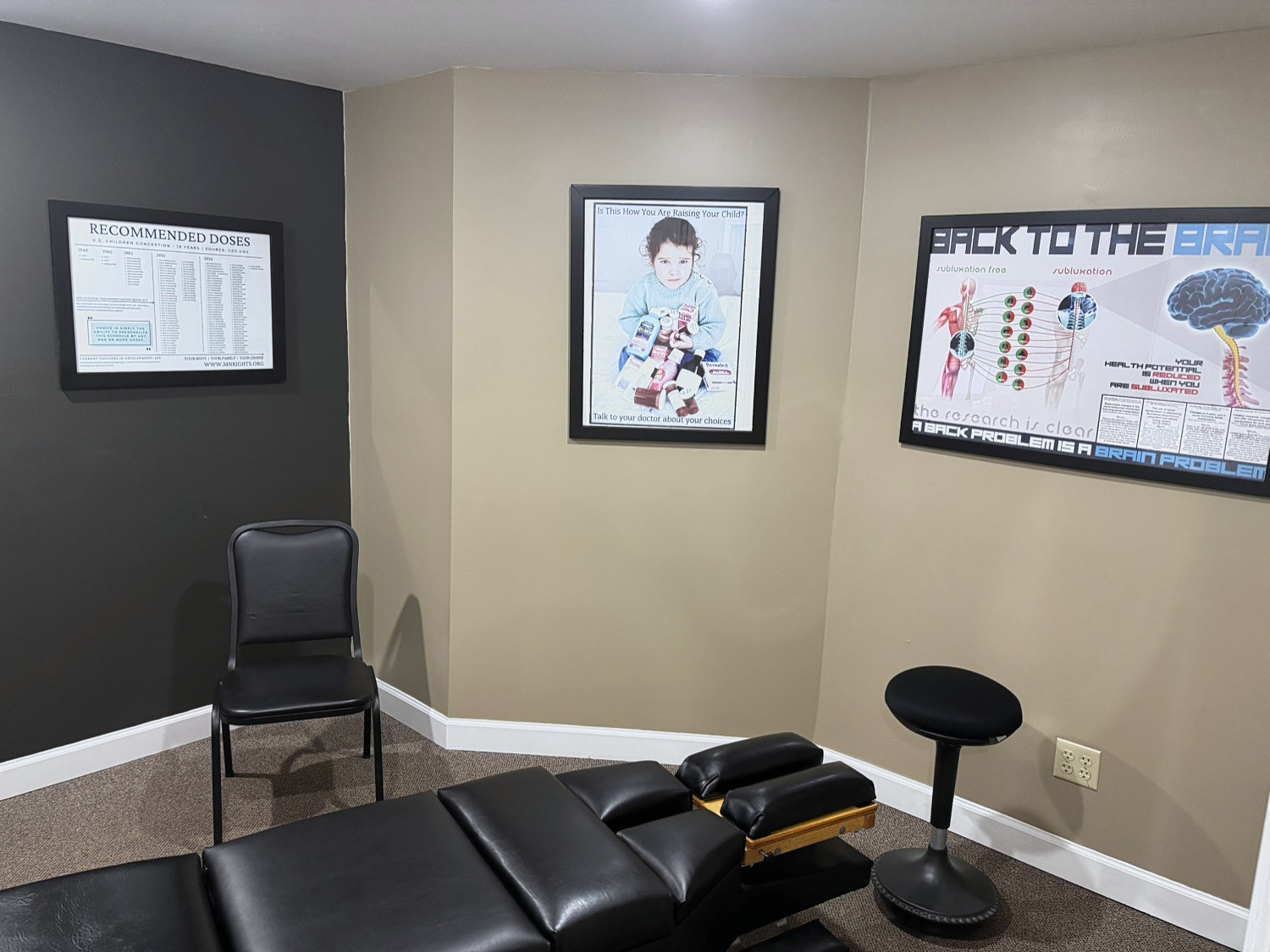 Chiropractic treatment room with spine and nervous system education posters